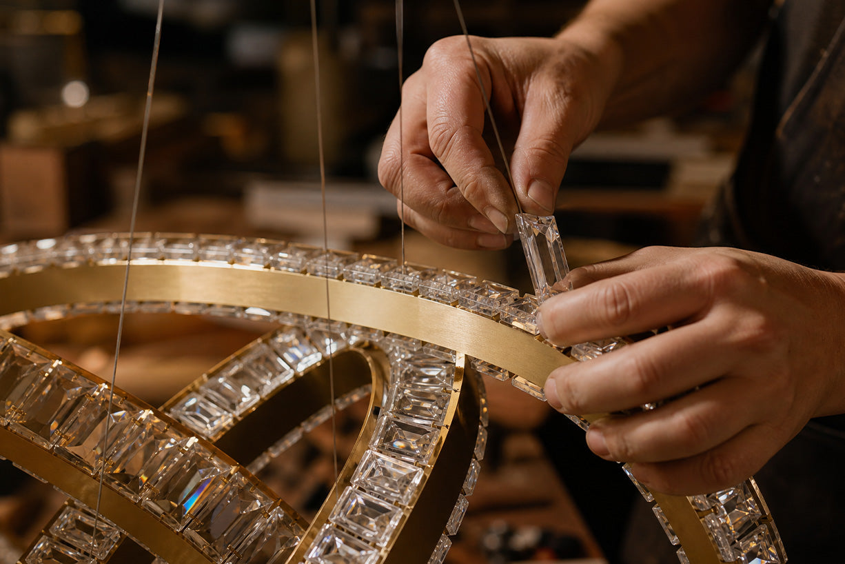 Artisan setting crystals into a brushed brass ring