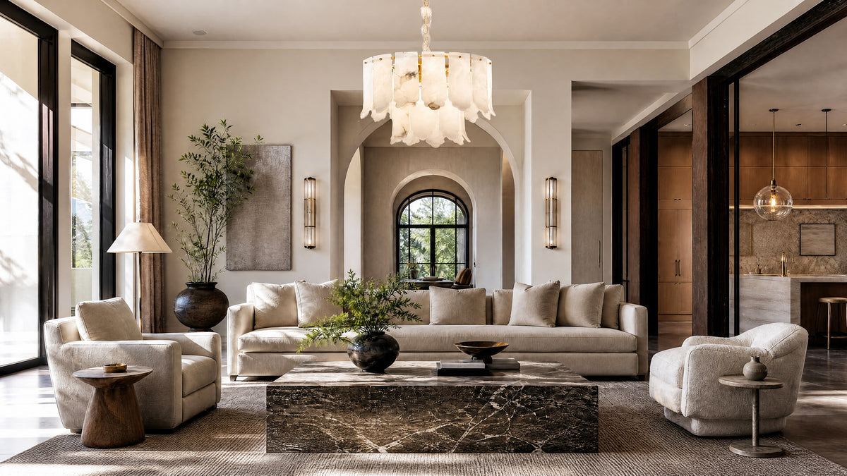 A luxury modern living room featuring a large white chandelier with layered petal-like shades, a beige sofa, matching armchairs, and a dark marble coffee table, set against warm beige walls with arched windows.